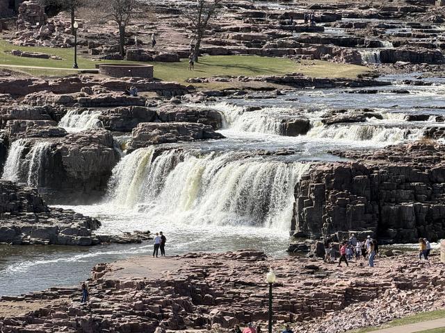 The falls of the Big Sioux River cascading over tiers of pink quartzite