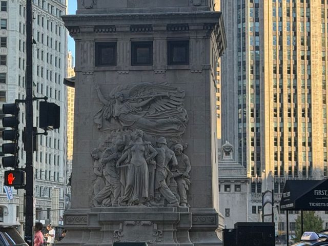A carved stone bridge tower on Michigan Avenue at Wacker Drive